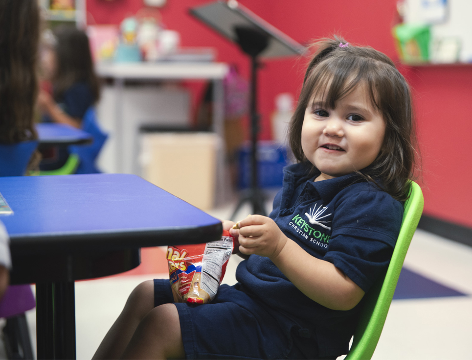 A beautiful K3 student enjoying snack time.